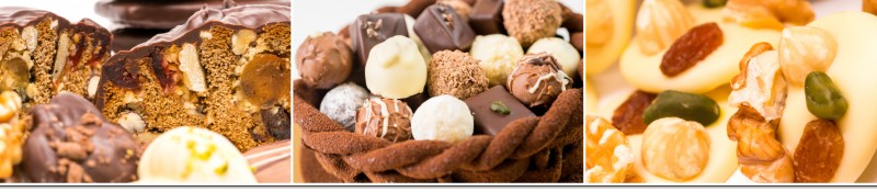 Gebäck mit Schokoladenüberzug, Pralinen im Schokoladenkorb und Schokoladentaler mit Nüssen